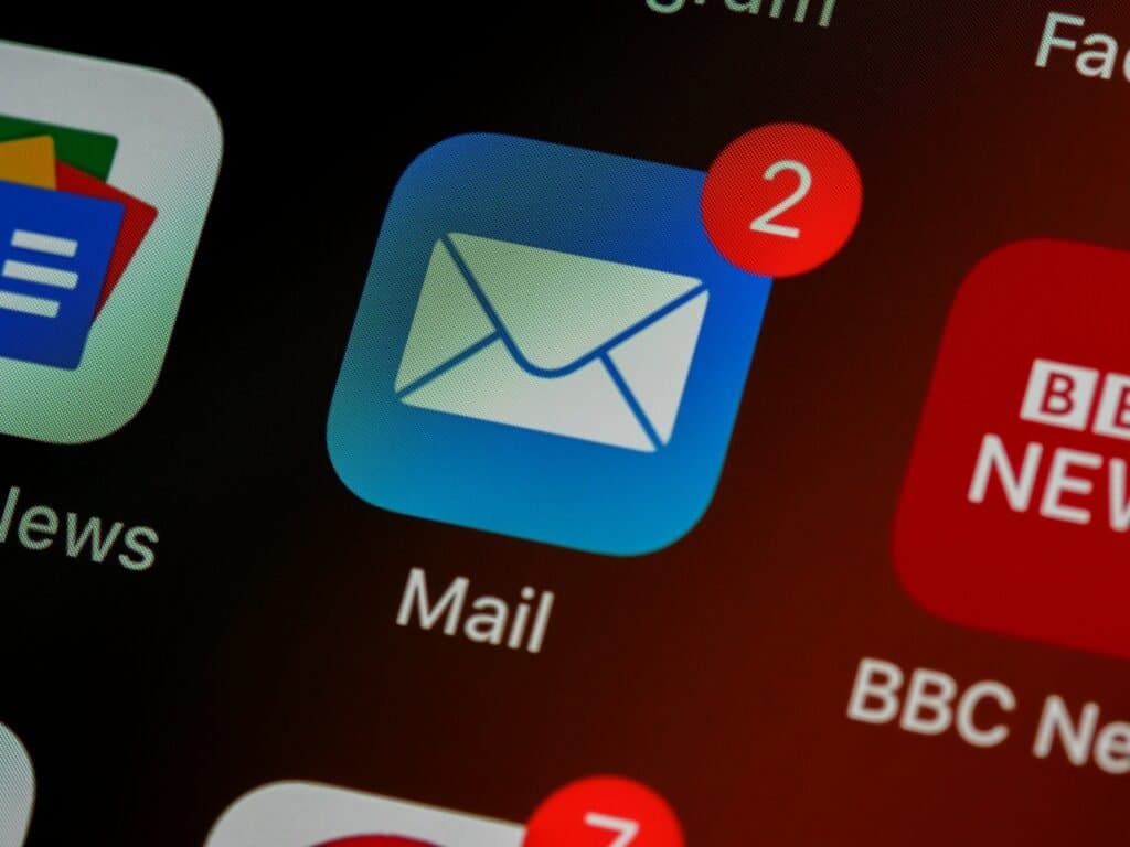 Mail app icon with a new message badge on a phone screen, representing email campaigns reaching the inbox