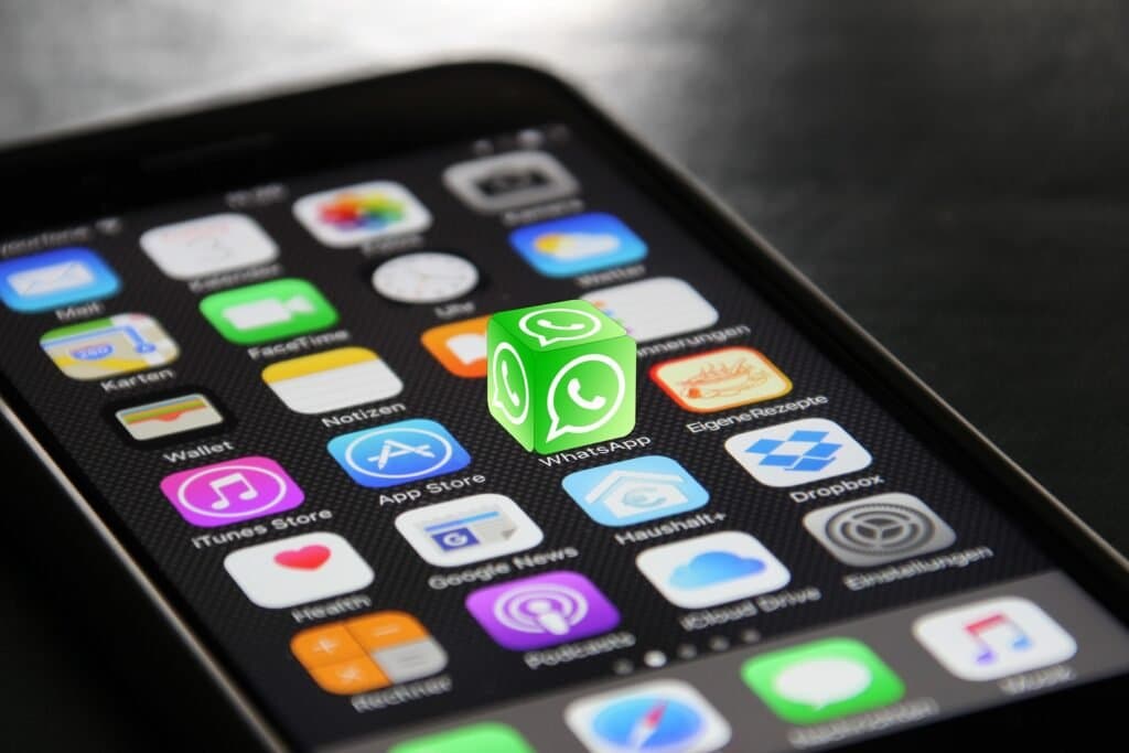 Smartphone home screen with the WhatsApp icon highlighted, representing WhatsApp marketing campaigns by Aaga
